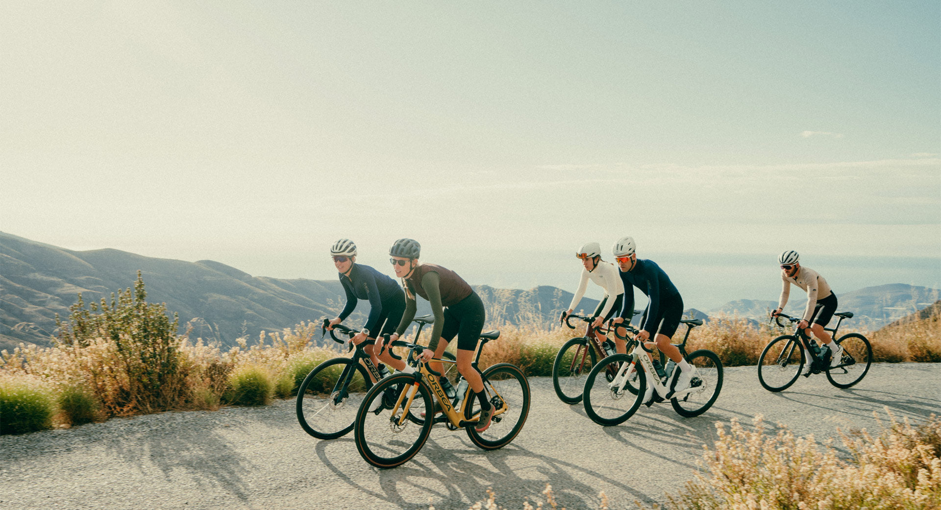 A group of people on the top of a mountain riding the orbea gain E-bike. 