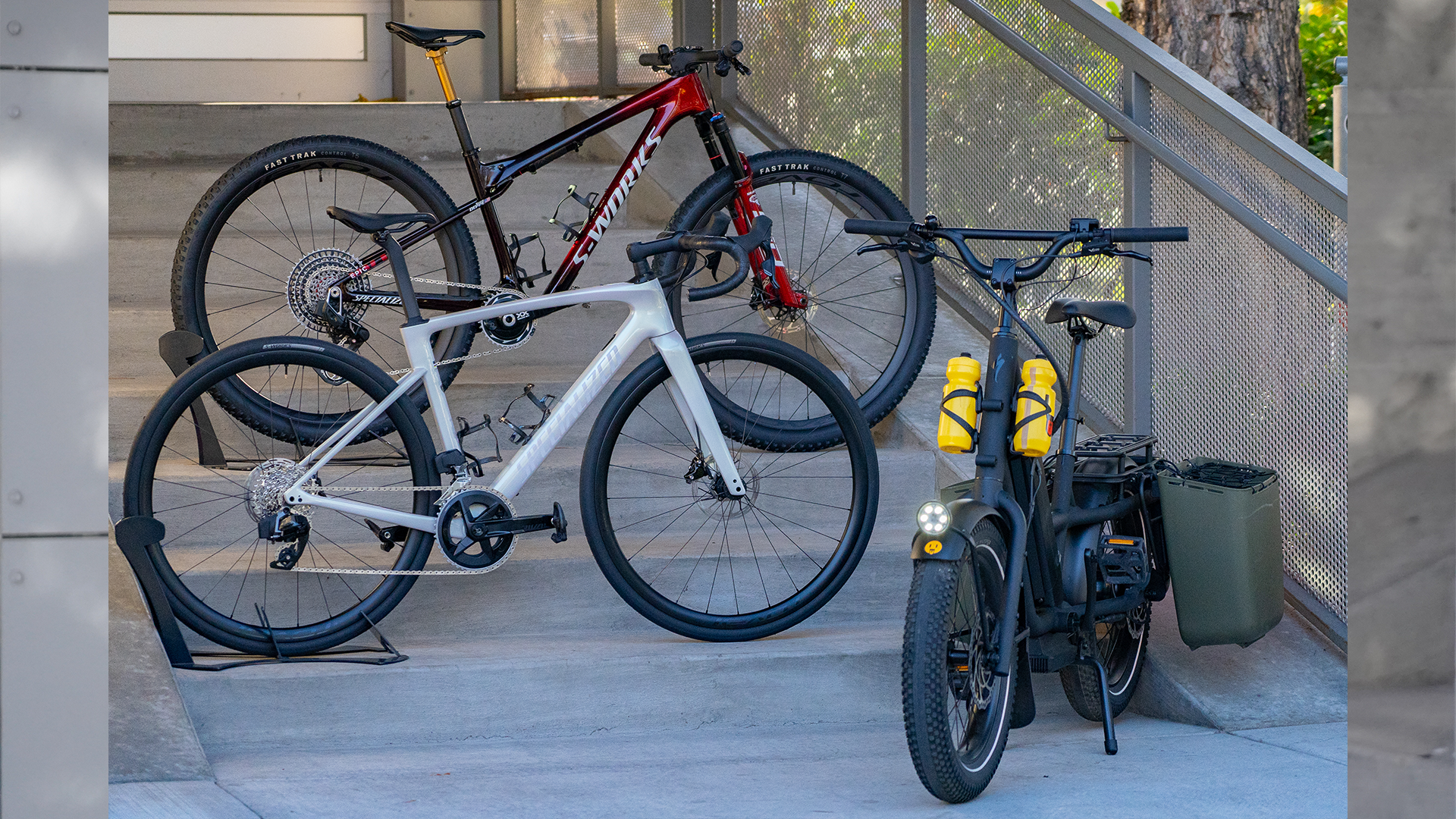 specialized bikes lined up on a grey staircase in front of a bike shop