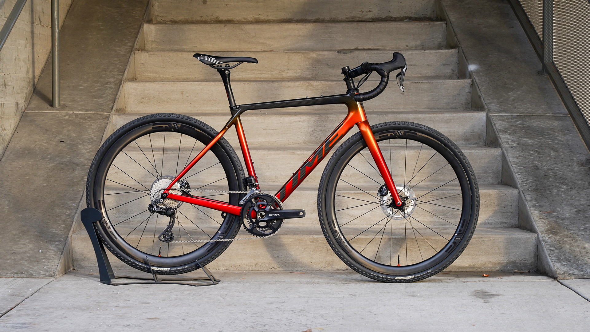 an orange time gravel bike with black detailing and drop handlebars