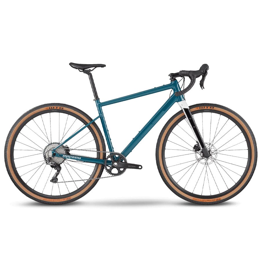 A BMC URS AL TWO bike that is blue with drop handlebars and tanwall tires