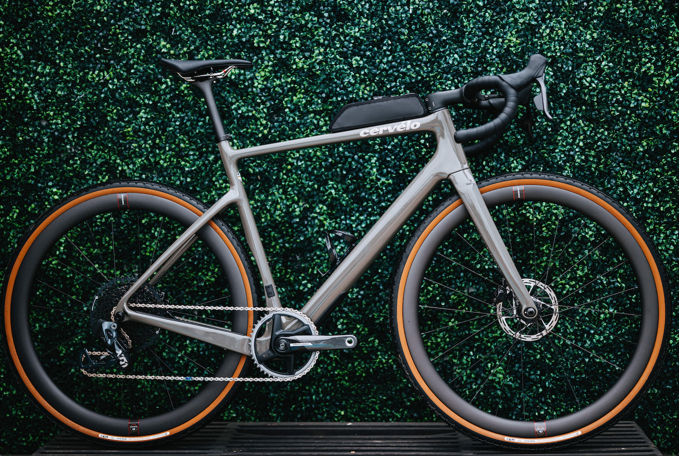 a gray cervelo aspero 5 sitting in front of a wall of plants