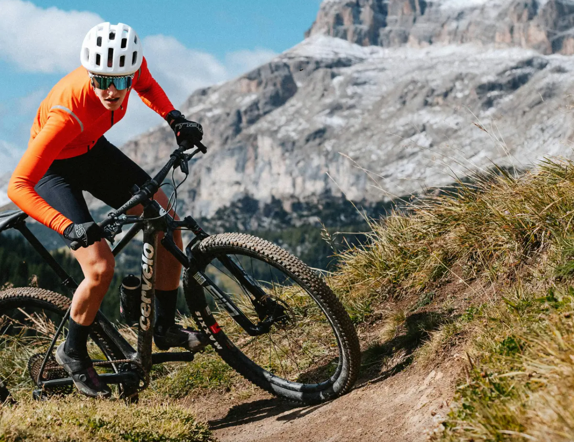 a man riding a cervelo zht 5 mountain bike up a dirt trail with mountains